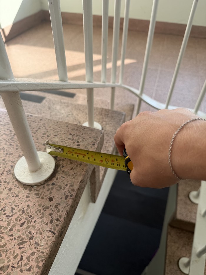 The old balustrade post base plate screwed to a terrazzo stair tread before removal